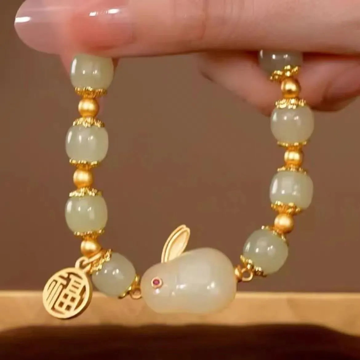 Green jade hare bracelet with fu character pendant on black hand-braided band
