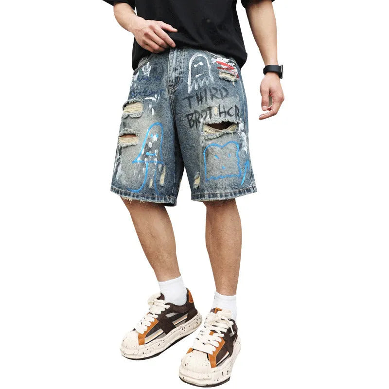 Blue distressed denim shorts with graffiti detail and ripped styling on mannequin