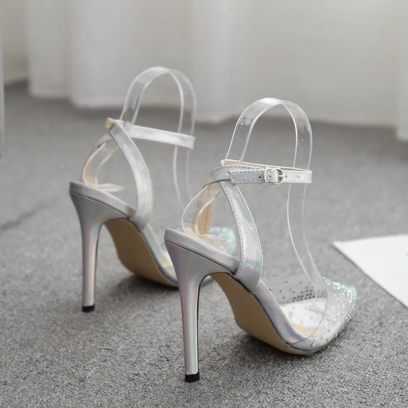 Women's pointed toe diamond sandals with stiletto heel and strappy PVC upper.