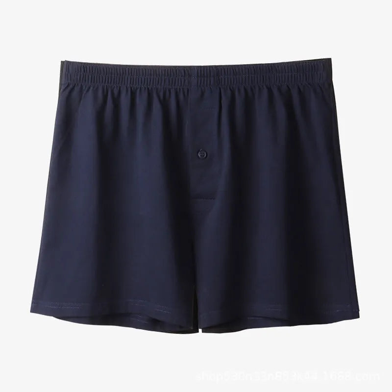 Men's solid colour cotton boxer shorts with a high waist and loose fit on a neutral background.