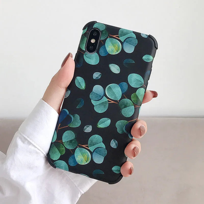 Black silicone phone case with a leaf design for various iPhone models.