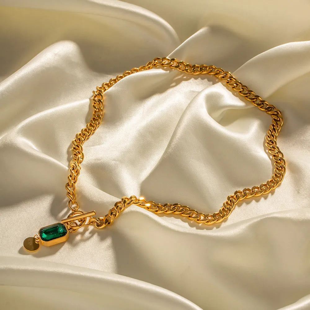Gold electroplated titanium steel necklace with geometric pendant and emerald zircon stone on Cuban link chain