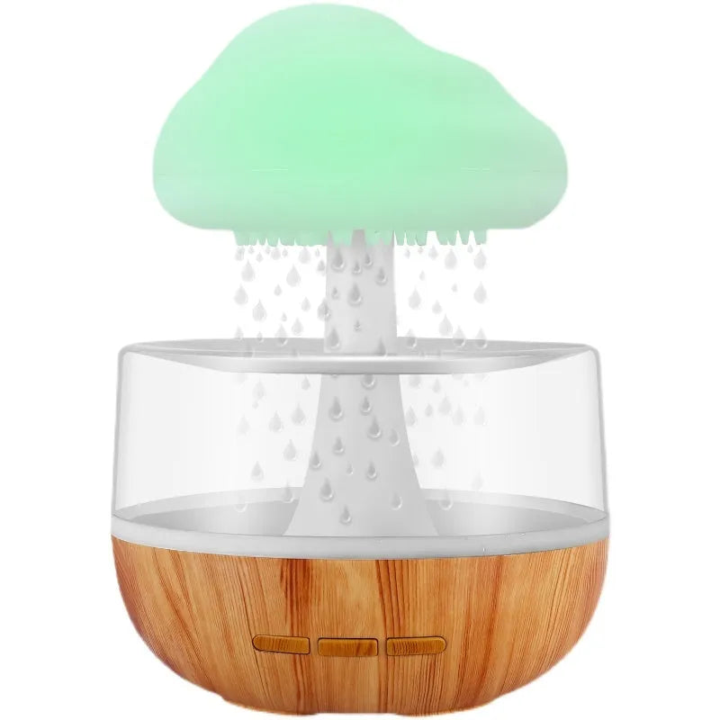 White cloud-shaped humidifier with coloured night light and mist output on a table