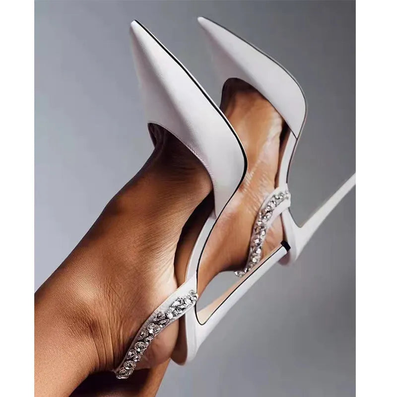 Women's black patent leather pointed toe high heel sandals with rhinestone details on the strap.
