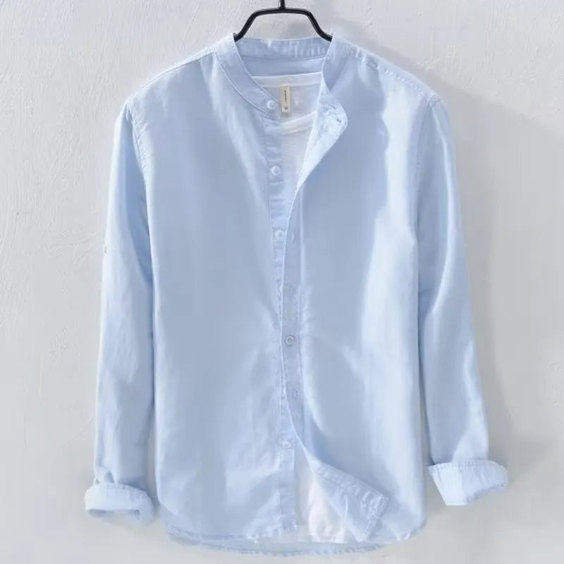 Man wearing a loose fit light blue cotton linen long sleeve casual shirt.