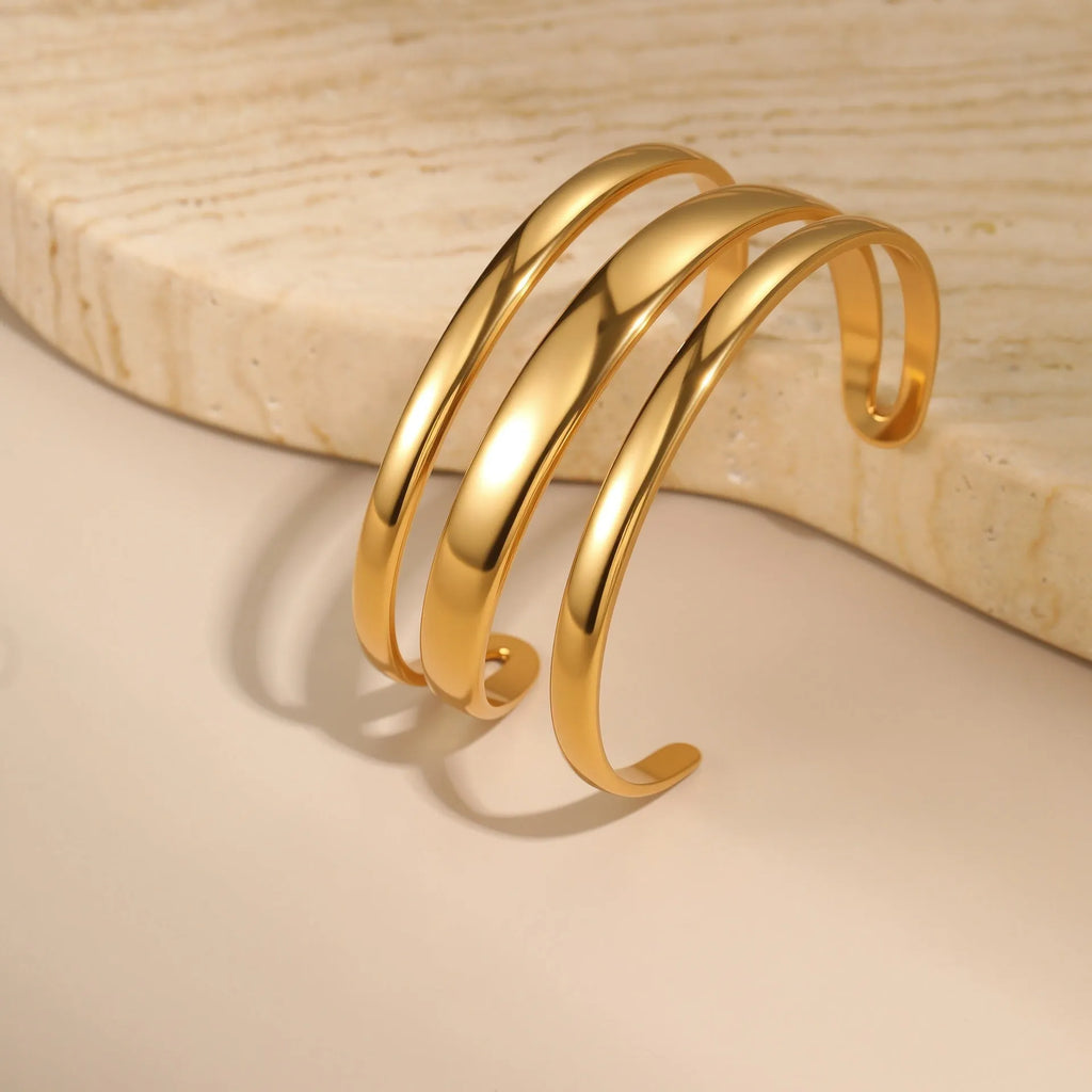 Geometric line stainless steel bracelet for women in gold tone or steel finish.
