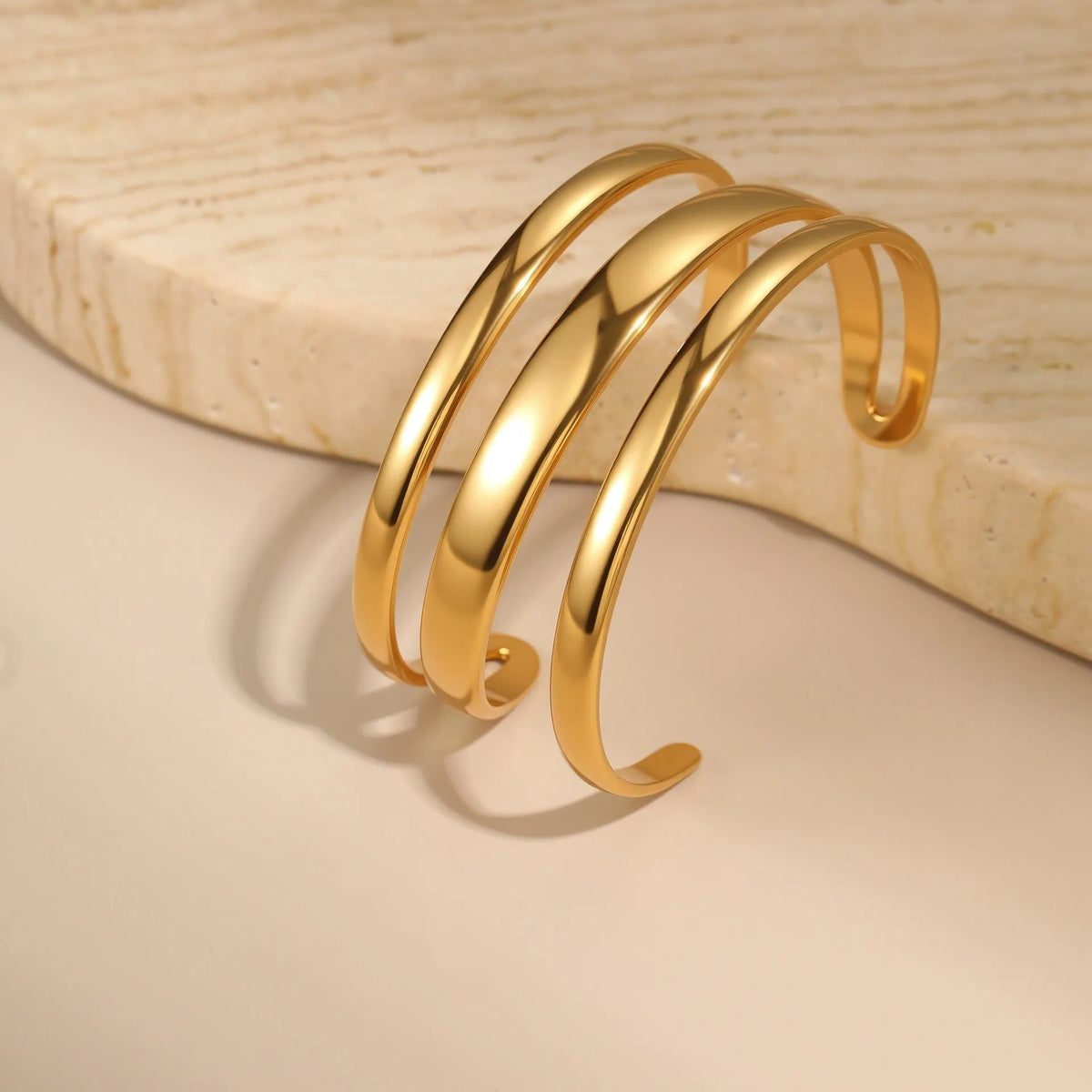 Geometric line stainless steel bracelet for women in gold tone or steel finish.