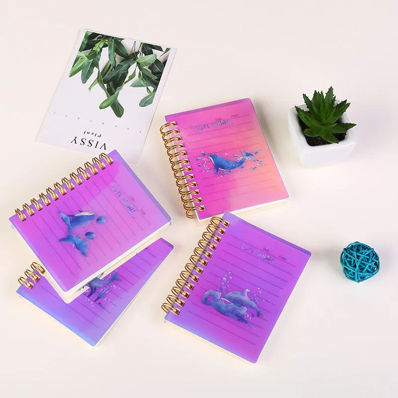 Four A7 spiral-bound pocket notebooks showing different PP cover designs: Constellation, Sakura, Universe, and Ocean.