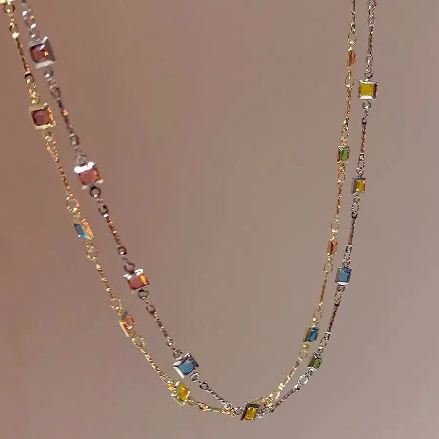 Gold alloy geometric necklace with a square colour artificial crystal pendant on a clavicle-length chain.