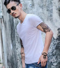 Man wearing a lightweight short sleeve summer T-shirt in a solid colour.