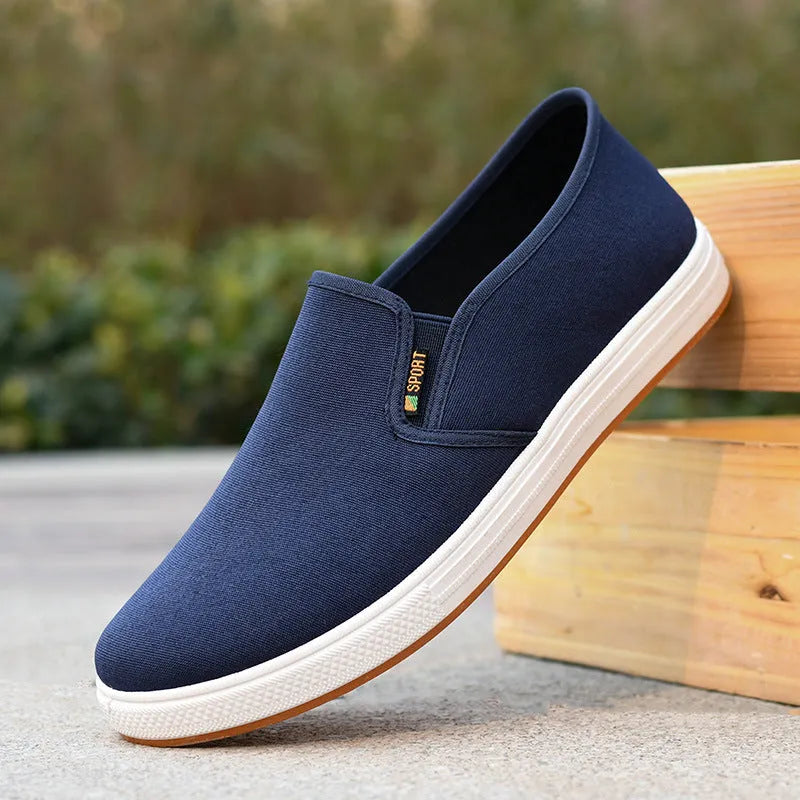 Men's black low-top canvas slip-on shoes with round toe and composite sole