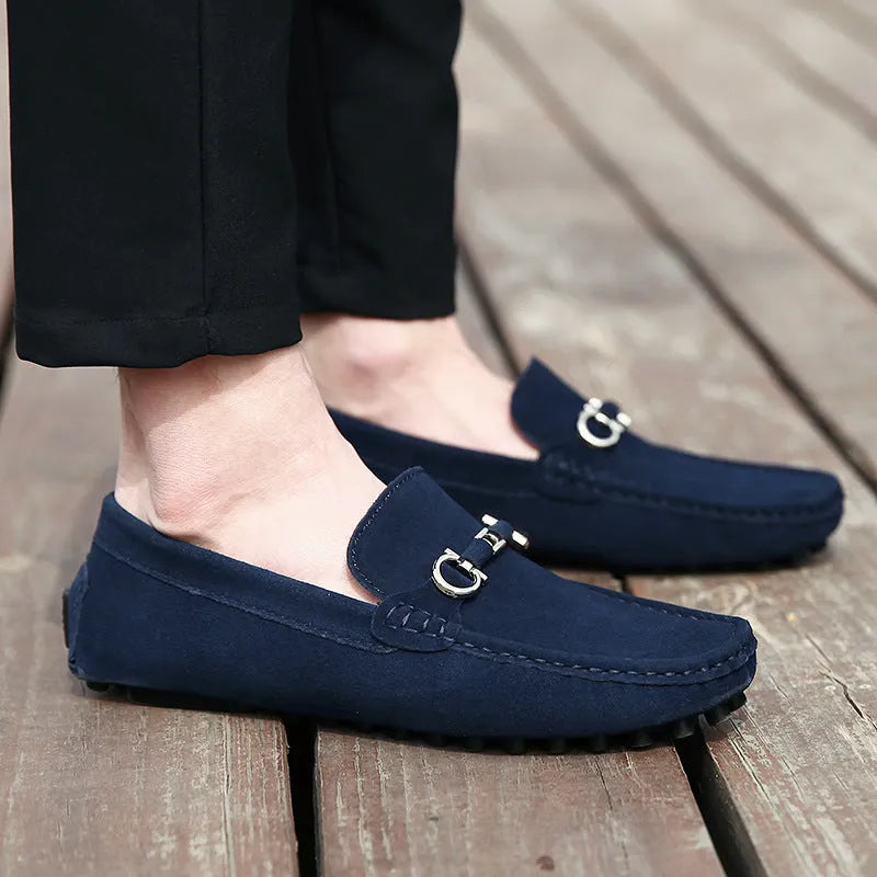 Men's black slip-on cowhide leather shoes with square toe and visible stitching on a rubber sole.