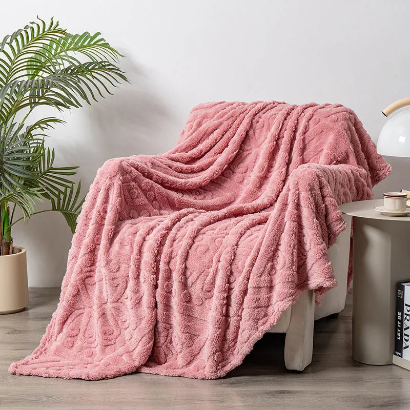 Shu cotton velvet jacquard sofa blanket in a solid colour draped over a modern sofa