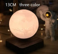 Magnetic levitation 3D moon night light, 14cm diameter, floating above a wooden base with touch switch.