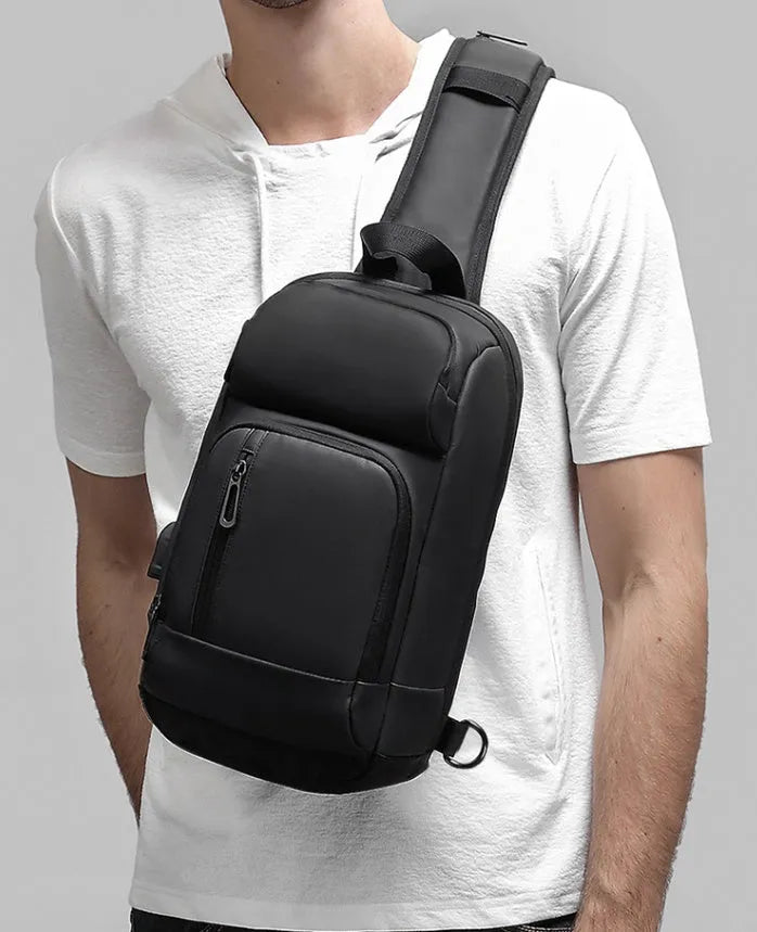 Black medium-sized PVC shoulder bag with zipper, showing internal organiser pockets and an air cushion shoulder strap.