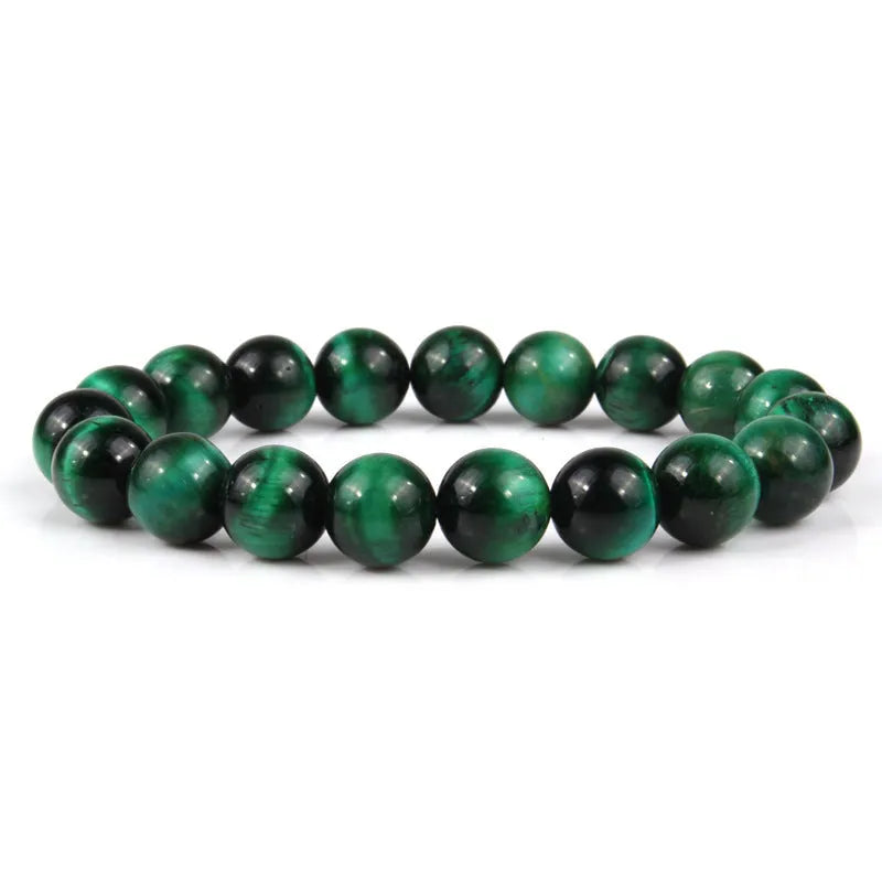 Natural tigereye crystal beaded bracelet with round beads, shown in a selection of colours and sizes on a wrist.