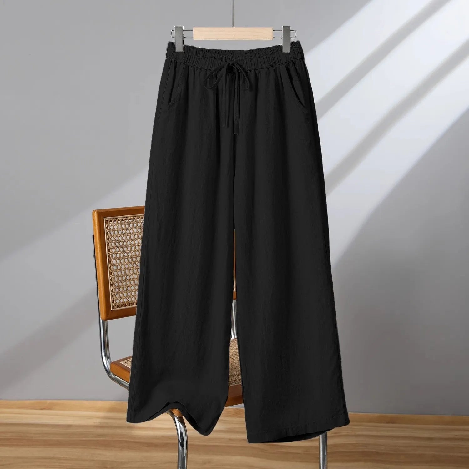 Women's straight-leg casual trousers in apricot colour with an elastic and drawstring waistband.