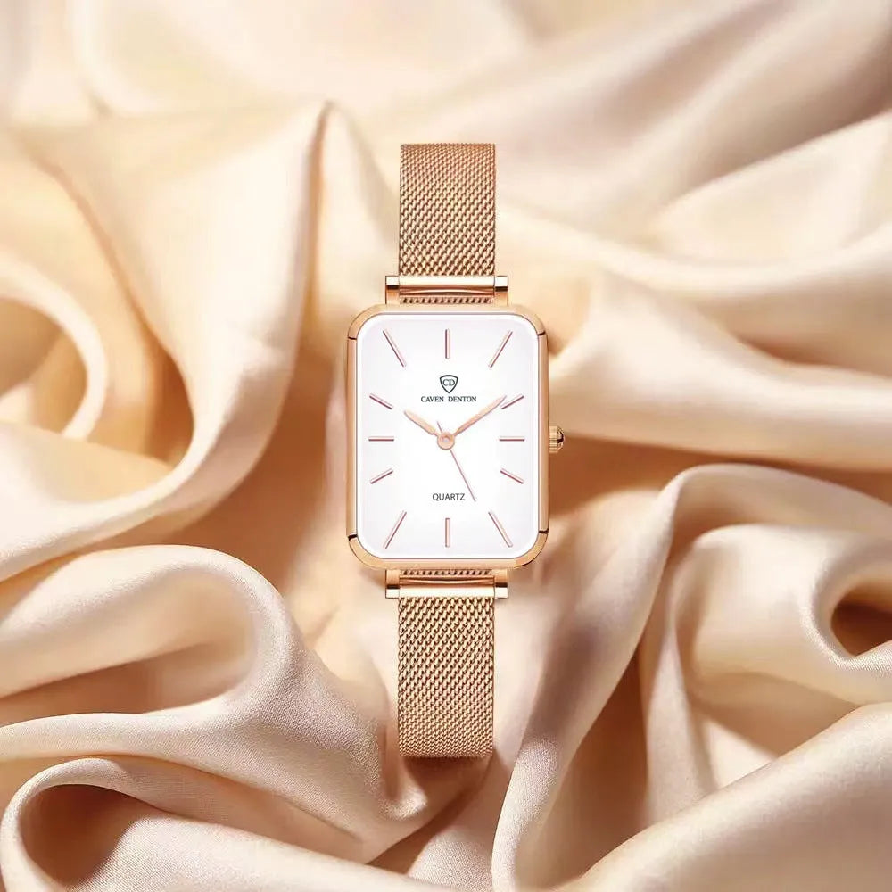 Rose gold women's waterproof quartz watch with woven steel strap on wrist.
