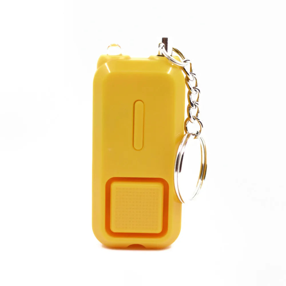 Small pink personal safety alarm on a keyring with a white box.