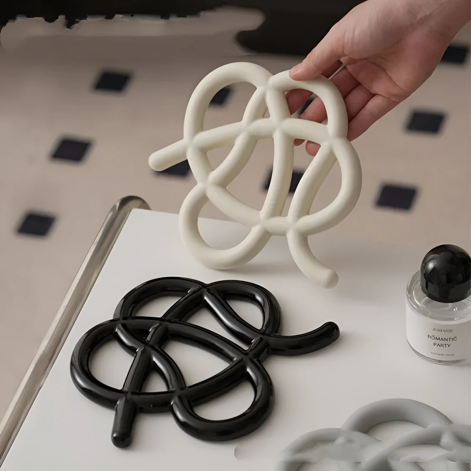 Ceramic heat proof mat in irregular shape on a wooden table