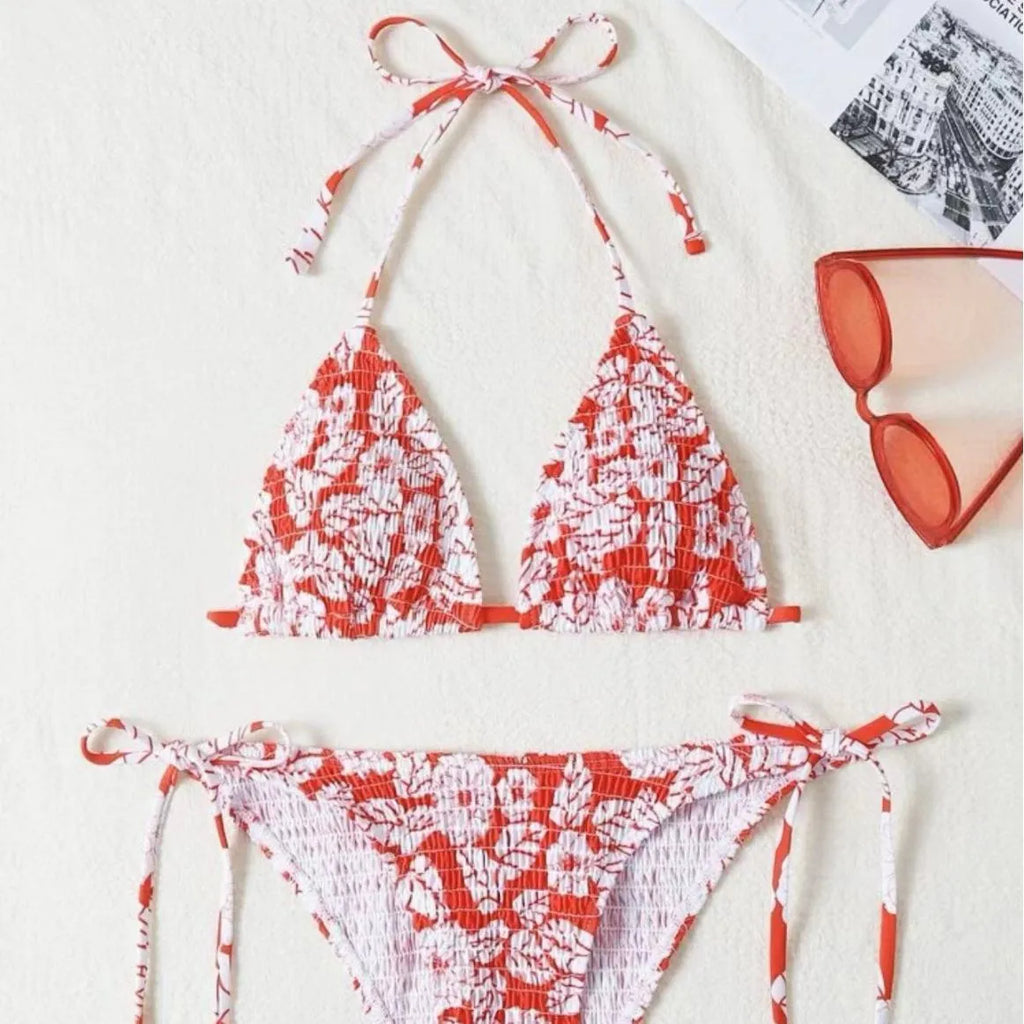 Women's floral print halter bikini swimsuit in light blue colour on a mannequin.