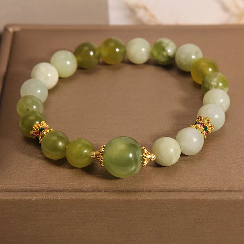 Women's jade bracelet in Xiuyan jade green colour with original design on wrist.