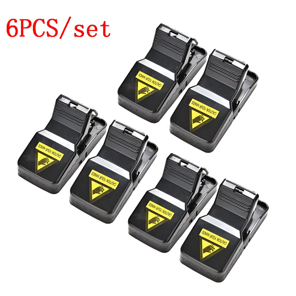 Six black plastic snap mousetraps laid out, each measuring 11 cm long.