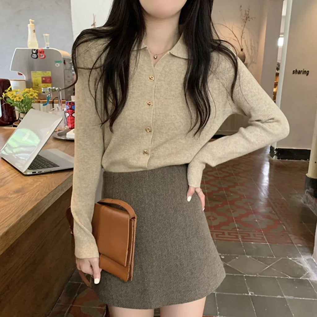 Beige viscose knitted long-sleeved cardigan with loose fit design on hanger