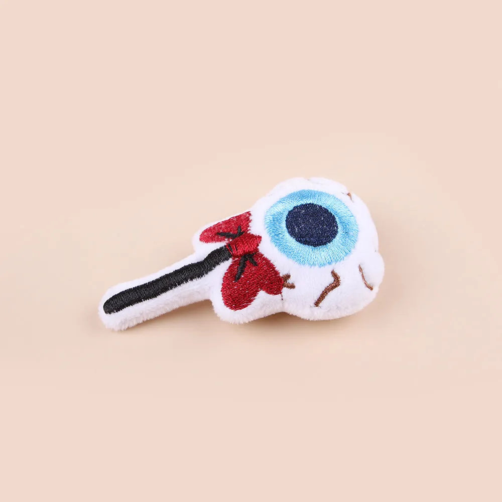 Small cat teaser toy with eyes, candy and skull plush designs on lightweight wand