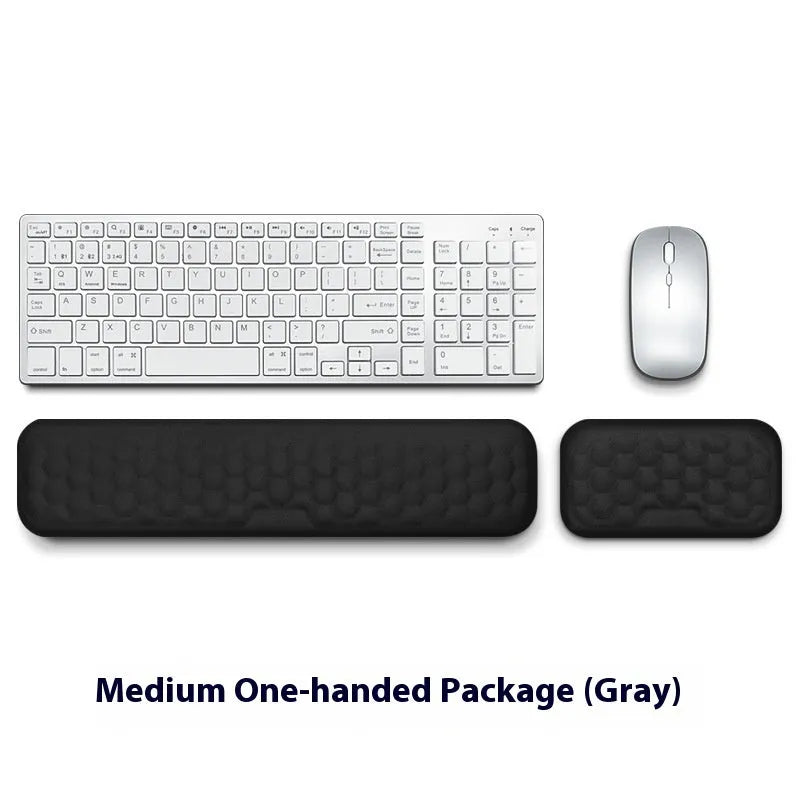 Memory foam mouse wrist pad with silicone bottom in black cloth cover on computer desk