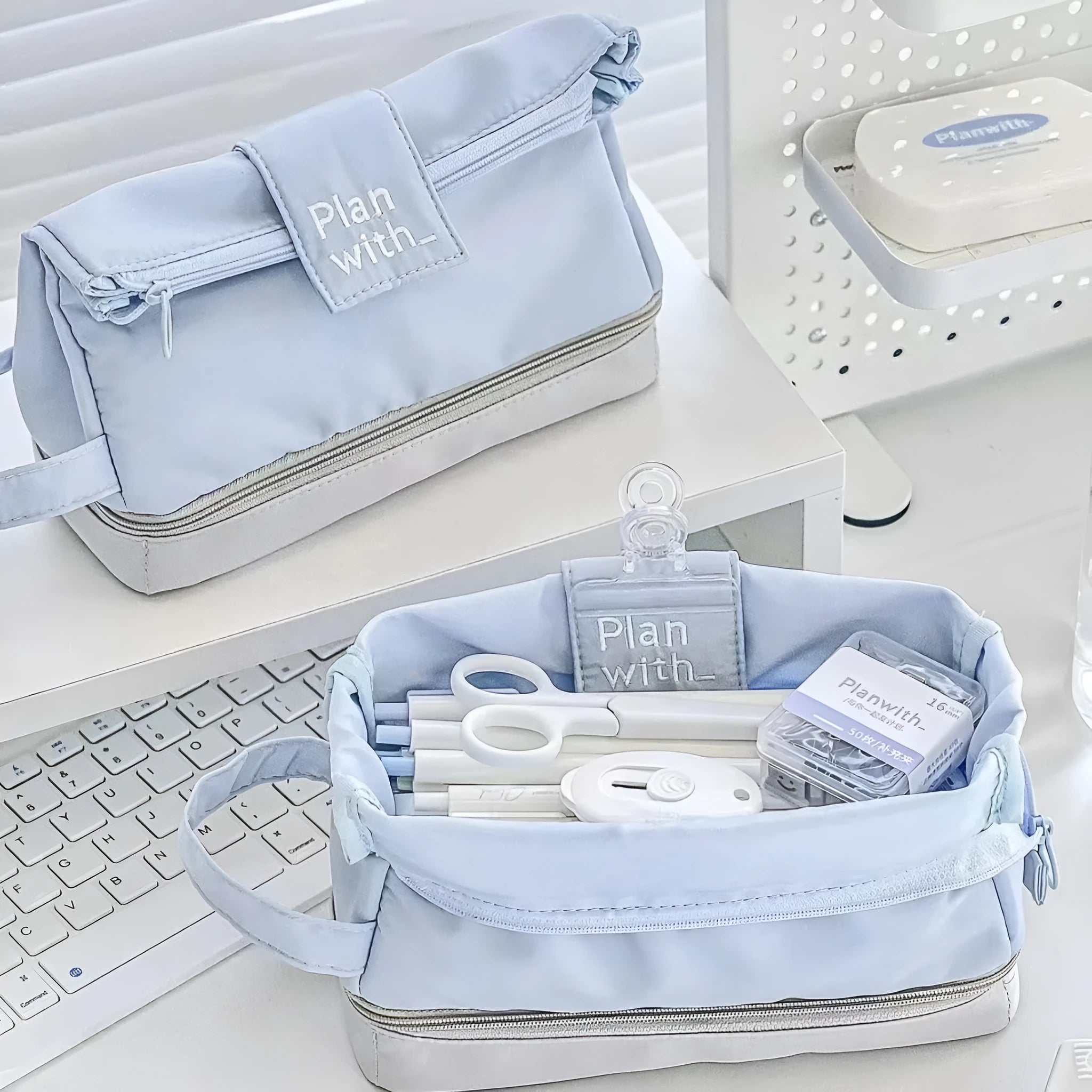 Dark blue folding double-layer polyester pencil case for students, also shown in blue and cream white.