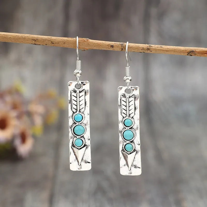 Long strip silver earrings with geometric shape and turquoise colour inlay