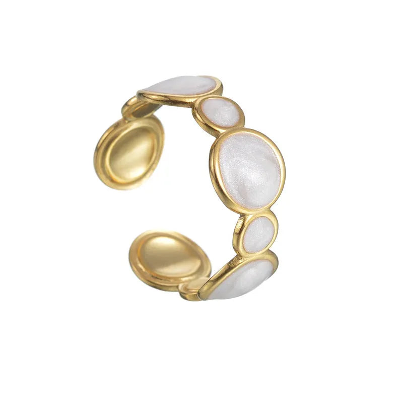Adjustable geometric stainless steel ring for women on a plain background.