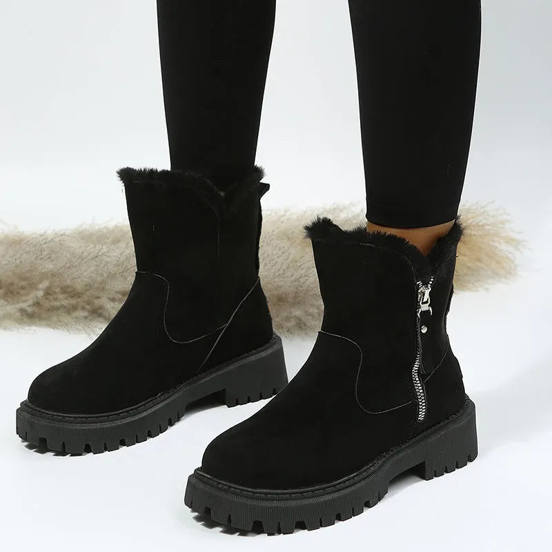 Women's black faux suede high-top snow boots with side zipper and faux fur lining.