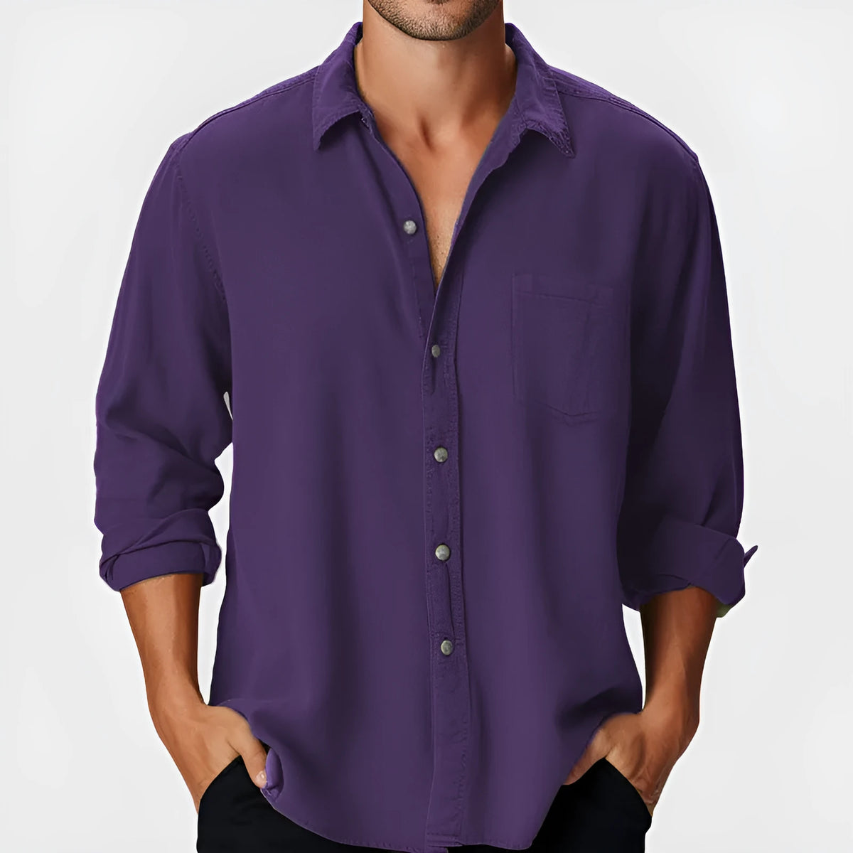 Man wearing a loose-fit long sleeve holiday shirt with a stand collar on a beach.