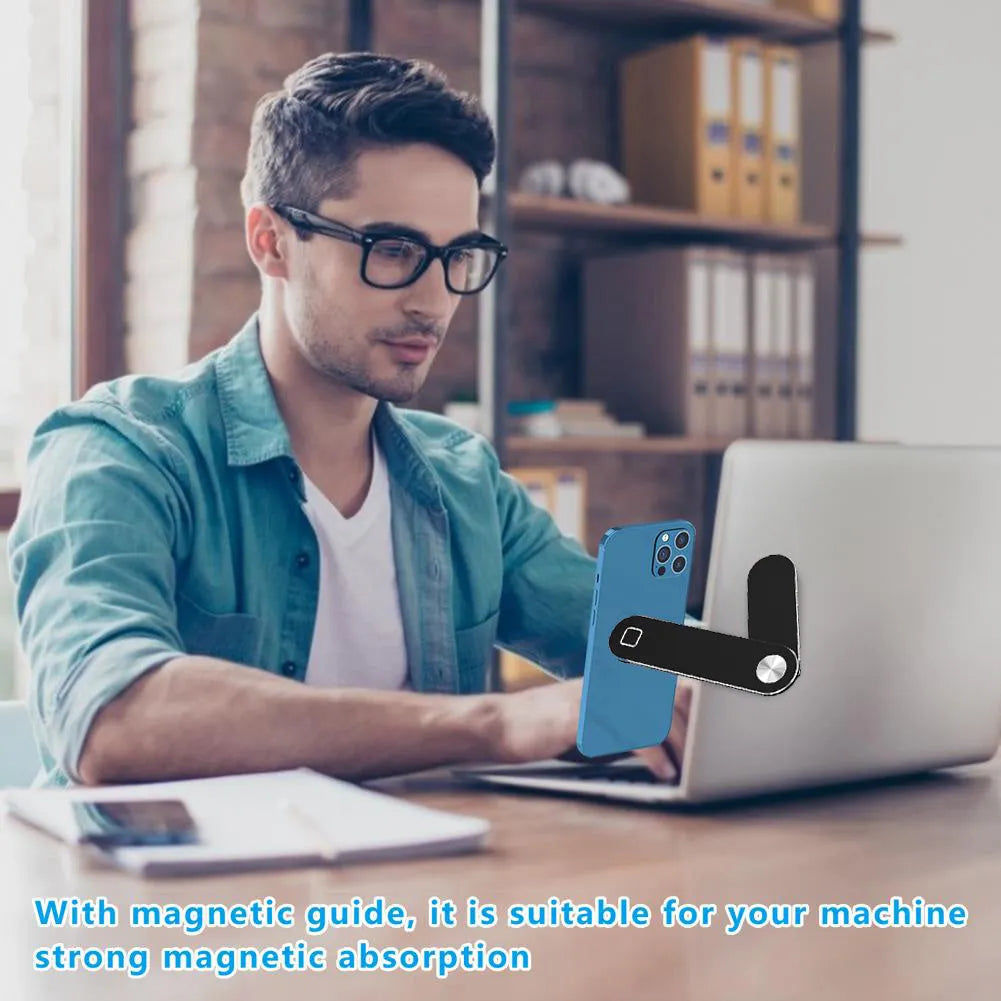 Black aluminum laptop phone holder mounted beside computer monitor showing smartphone attachment