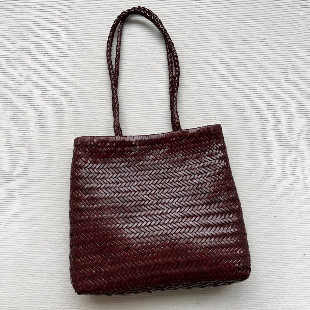 Brown woven leather tote bag with three-dimensional outer pocket and genuine cowhide construction