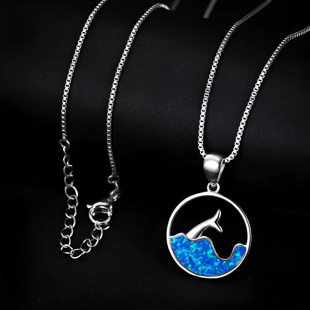 A geometric round opal pendant necklace with a fishtail design on a chain.