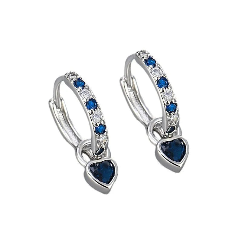 Women's gold-coloured heart drop earrings with a blue zircon stone centre and clip-on fastening.