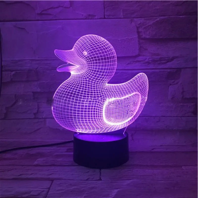Little Yellow Duck 3D LED night light on a table showing its colourful illuminated display and remote control.