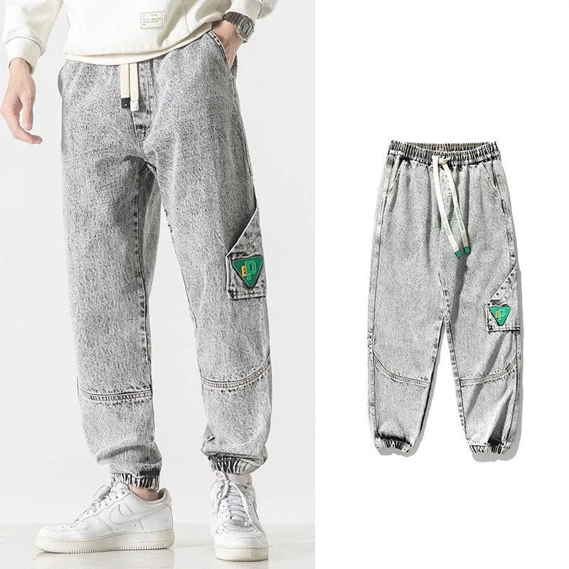 Men's loose-fit tapered cotton trousers in black, blue, or grey on a mid-waist.