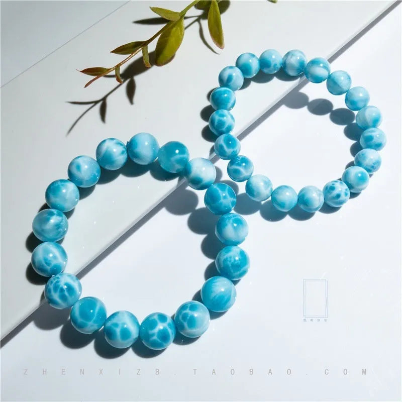 Blue Bodhi bracelet with natural sea-pattern crystal bead and pearl details in Maillard style.