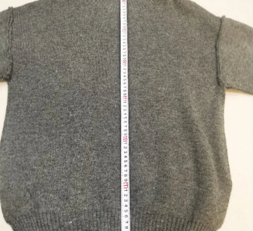 Women's dark grey acrylic jumper suit with side slits on the top and matching trousers.