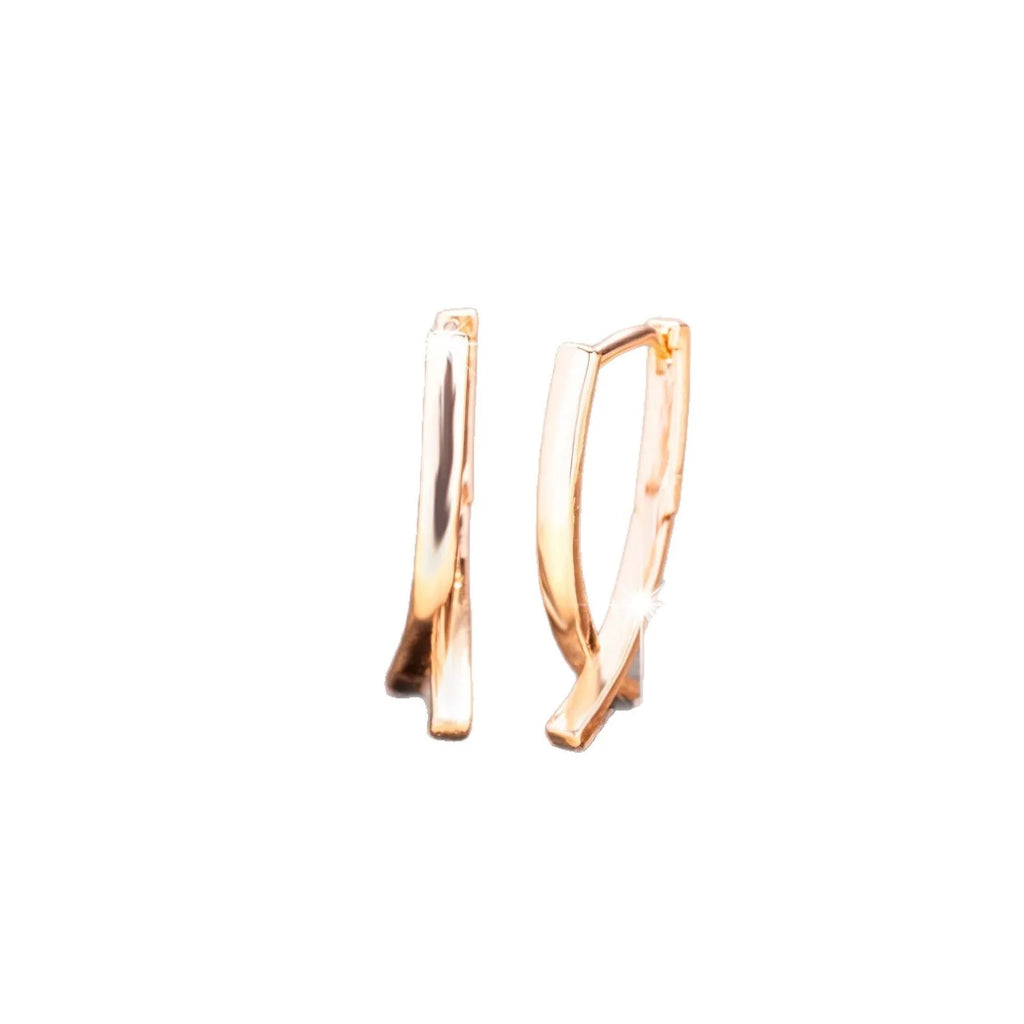 Rose gold cross shaped earrings made from copper with geometric design