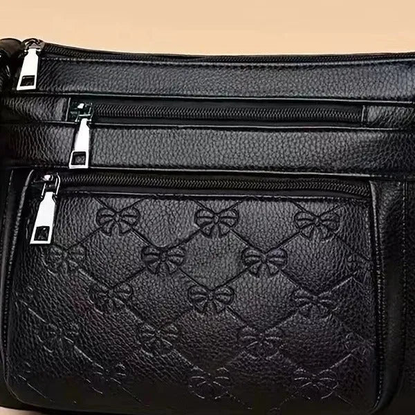 Butterfly black PU leather crossbody messenger bag showing embossed texture and sewing thread details