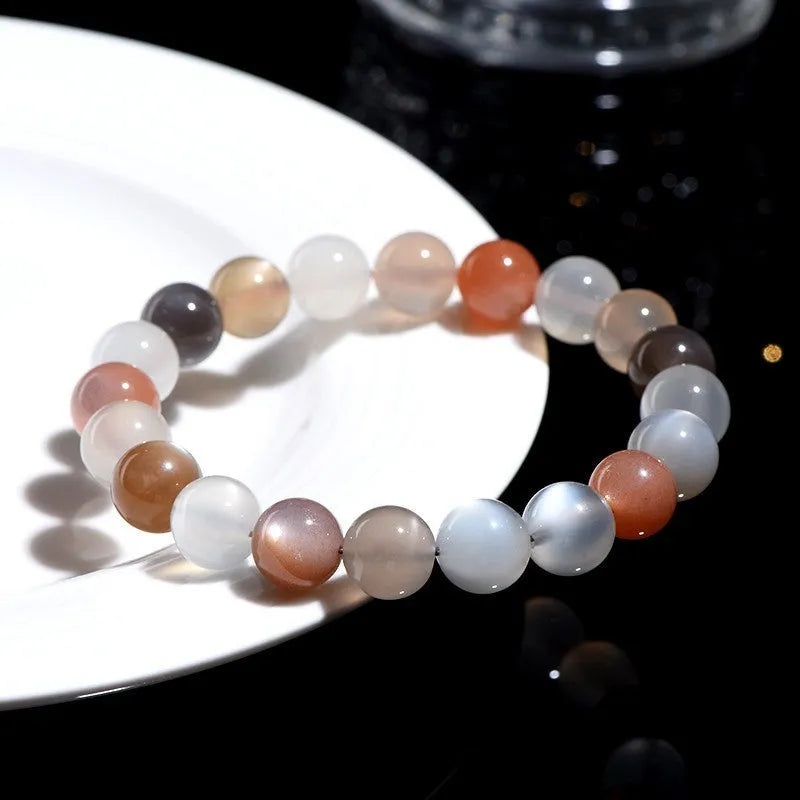 Natural colourful moonstone unisex bracelet with 8mm beads on a wrist.