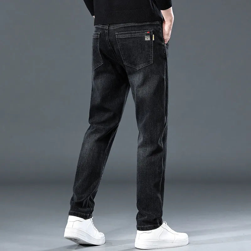 Man wearing slim straight blue grey casual trousers with a zip fly and mid waist.