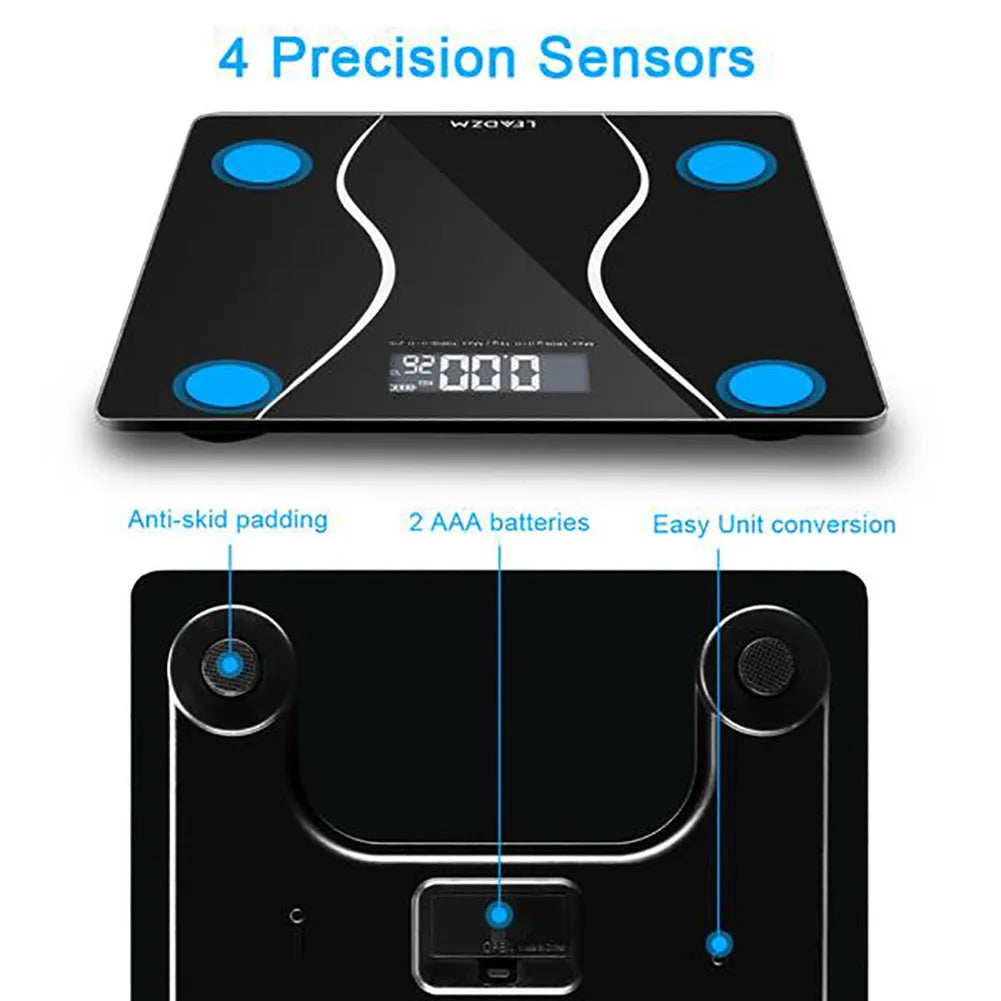 Black electronic bathroom scale with LCD display on a bathroom floor.