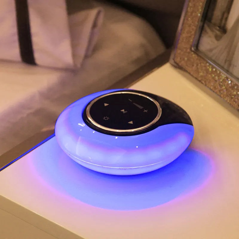 Blue and white Bluetooth desk lamp with speaker, shown folded and unfolded on a wooden desk