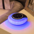 Blue and white Bluetooth desk lamp with speaker, shown folded and unfolded on a wooden desk